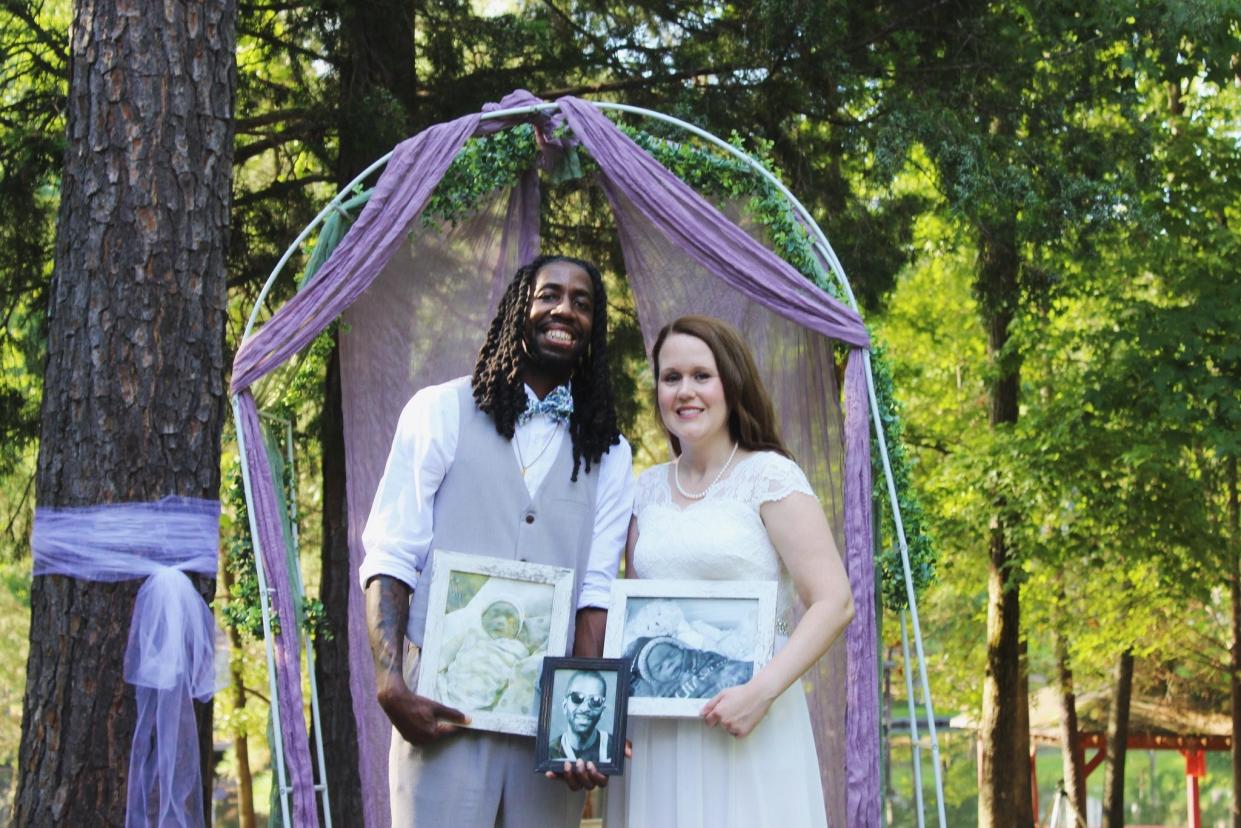 New Beech Grove basketball coach David Sanders and wife, Aimee, with photos of their two sons, Kingston and Karson, who were stillborn.