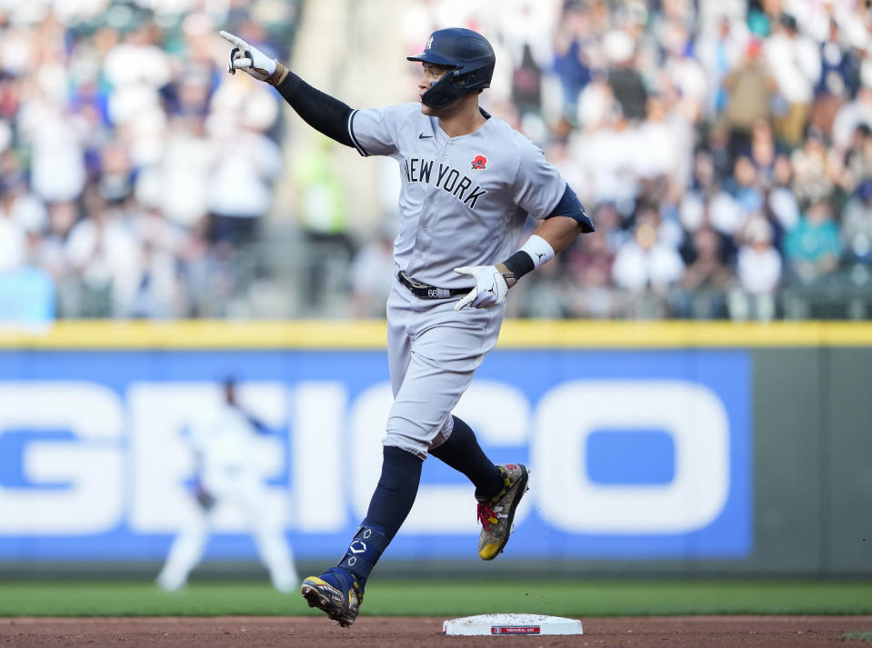 New York Yankees' Aaron Judge points to the bullpen as he runs the bases after hitting a two-run home run against the Seattle Mariners during the third inning of a baseball game Monday, May 29, 2023, in Seattle. (AP Photo/Lindsey Wasson)