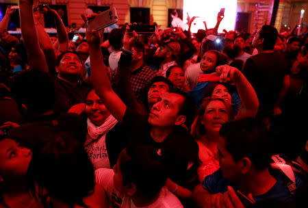 People take pictures as Presidential candidate Nayib Bukele of the Great National Alliance (GANA) speaks to his supporters after official results in downtown San Salvador, El Salvador, February 3, 2019. REUTERS/Jose Cabezas
