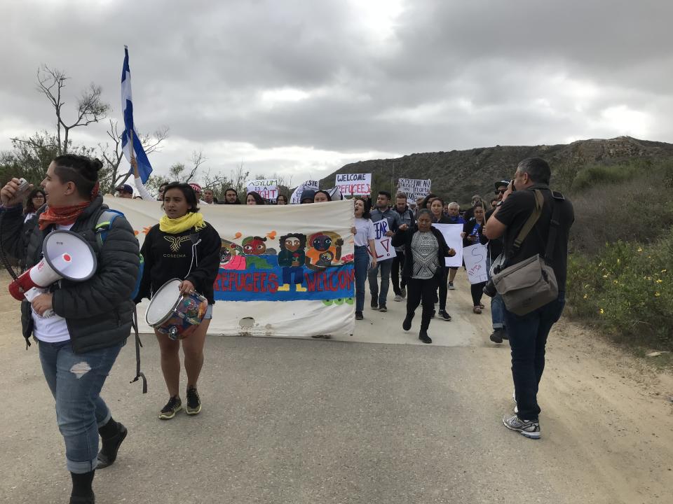 A group of several dozen immigrant rights activists and legal observers march toward the U.S.-Mexico border in San Diego on April 29. They're there to witness the arrival of a caravan of Central American migrants who plan to request asylum in defiance of repeated threats from Trump administration officials. (Photo: Matt Ferner/HuffPost)