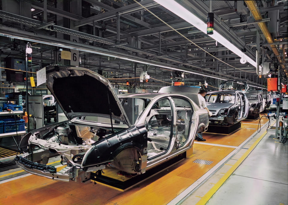 Metal shells of cars on a production line.