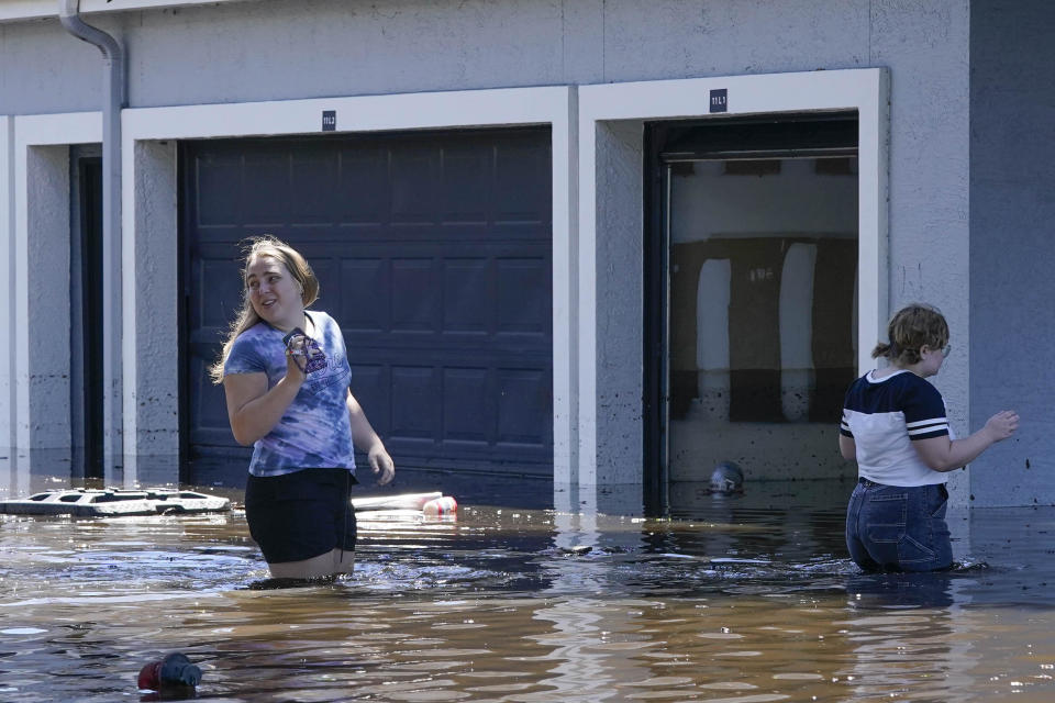 University of Central Florida students try to get into their apartment near the campus, which was totally flooded by rain from Hurricane Ian, on Sept. 30, 2022, in Orlando, Florida. / Credit: John Raoux / AP