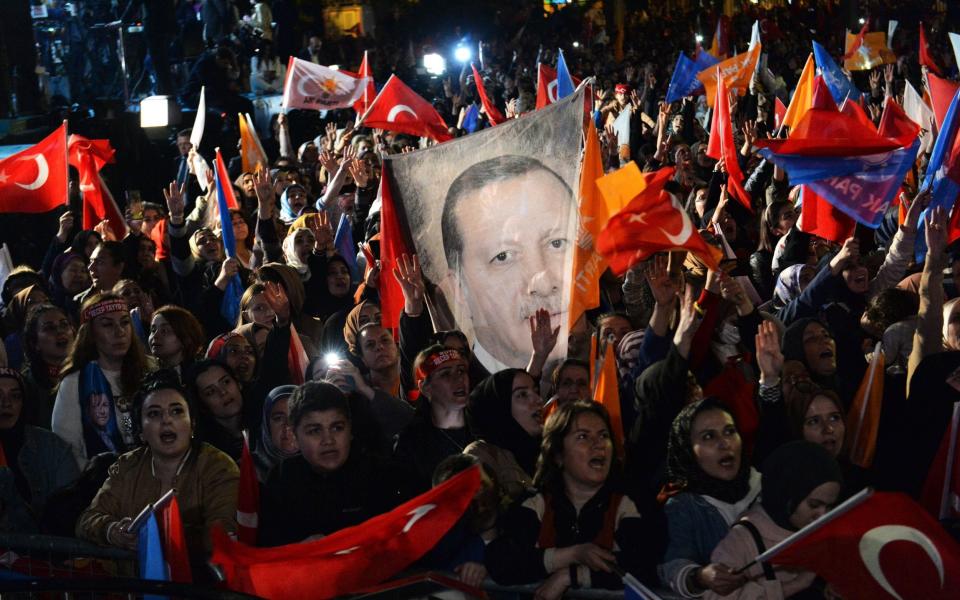 Supporters wave flags and banners for Turkish president and presidential candidate Recep Tayyip Erdogan - Necati Savas/Shutterstock