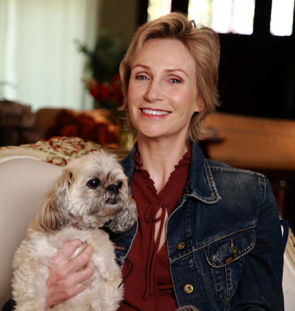 In this March 9, 2013 photo released by Shelter Me shows series host Jane Lynch posing with Olivia, an Lhasa Apso breed, in Venice, Calif. "Shelter Me" is an inspiring PBS series that celebrates shelter pets with positive and uplifting stories. (AP Photo/Austin Smoak, Shelter Me)