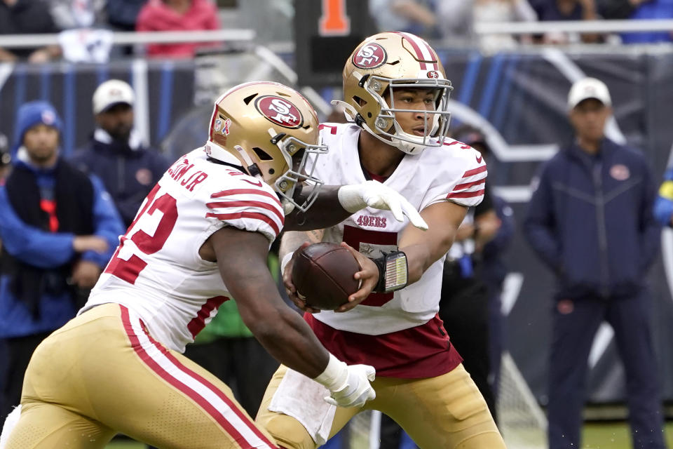 FILE - San Francisco 49ers quarterback Trey Lance hands off to running back Jeff Wilson Jr. during the team's NFL football game against the Chicago Bears on Sept. 11, 2022, in Chicago. The 49ers find themselves in a frustrating but familiar familiar spot: a starting running back has gotten hurt forcing the team to scramble for a solution. The Next man up after Elijah Mitchell went down with a knee injury that is expected to sideline him for about two months is Jeff Wilson Jr. (AP Photo/Charles Rex Arbogast, File)