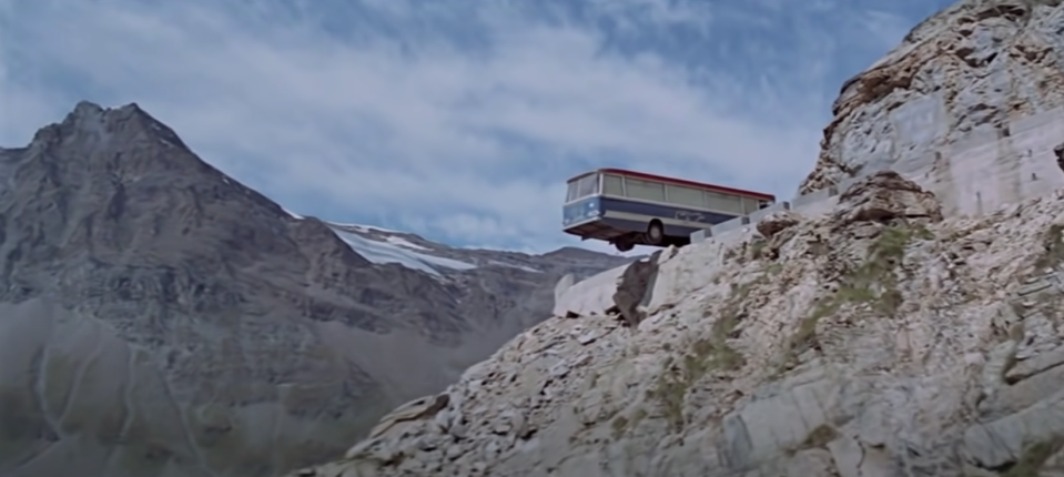 A van hangs off the side of a cliff