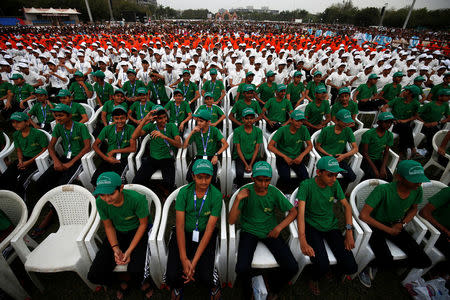 School students wait for Prime Minister Narendra Modi to address an election campaign meeting ahead of Gujarat state assembly elections, in Ahmedabad, December 3, 2017. REUTERS/Amit Dave
