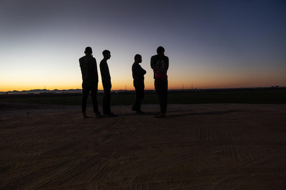 Immigrants seeking asylum in the United States wait to be processed by Border Patrol agents after crossing into Arizona from Mexico on Sept. 26, 2022, near Yuma, Arizona.