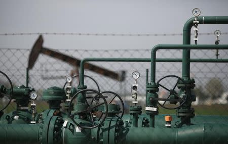 Pressure gauges stand in front of a pumpjack of Austrian oil and gas group OMV in an oilfield near Gaenserndorf April 8, 2014. REUTERS/Leonhard Foeger