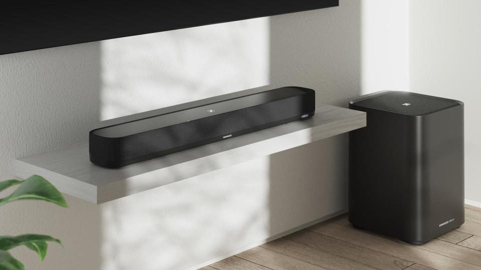Soundbar and subwoofer positioned beneath a wall-mounted TV