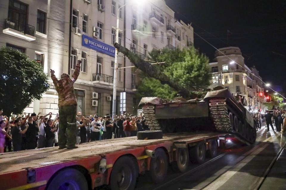 FILE - Members of the Wagner Group private military company load a tank onto a truck in Rostov-on-Don, Russia, on June 24, 2023, prior to leaving the headquarters of the Southern Military District. Prigozhin's uprising marked the most serious challenge to Russian President Vladimir Putin's rule in his more than two decades in power and badly dented his authority. President Vladimir Putin is likely to win another six-year term easily in an election expected in March, using his sweeping grip on Russia’s political scene to extend his tenure of over two decades in power. (AP Photo, File)