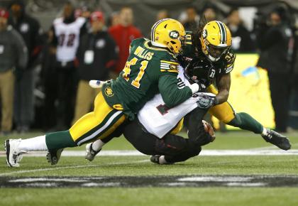 Ottawa Redblacks quarterback Henry Burris (1) is sacked by Edmonton Eskimos&#39; Odell Willis (41) and Marcus Howard (91) during the CFL&#39;s 103rd Grey Cup championship football game in Winnipeg, Manitoba, November 29, 2015. REUTERS/Mark Blinch