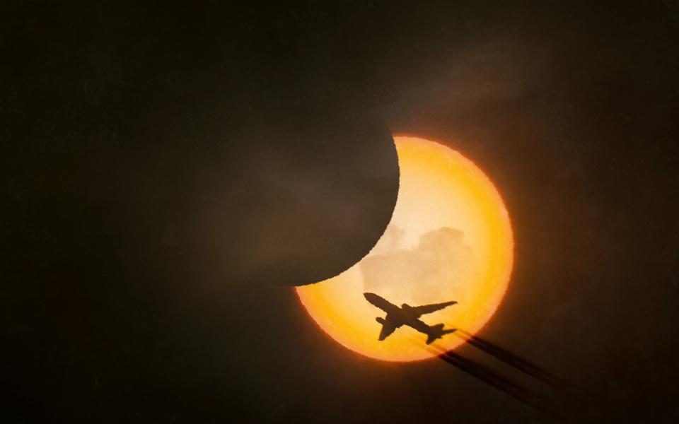 Solar eclipse with an airplane silhouette