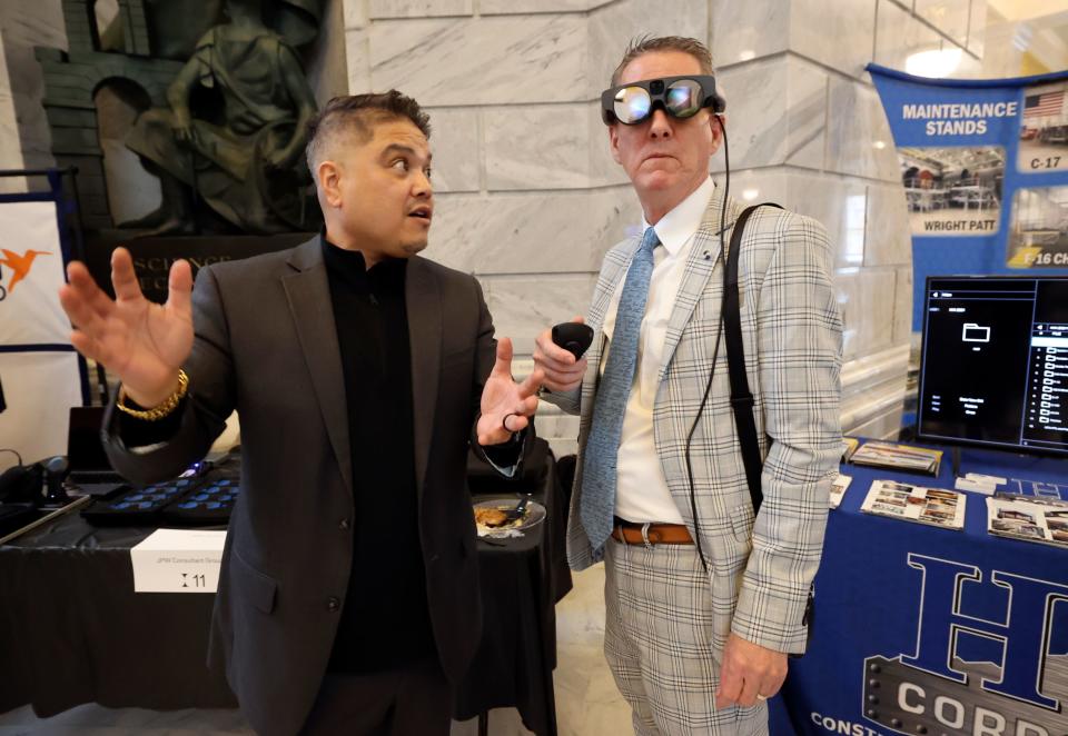 Maurice De Vera, Magic Leap director of account management, helps Dennis Leavitt, United We Pledge president, test out the Magic Leap 2 during Utah Aerospace and Defense Day on Capitol Hill at the Capitol in Salt Lake City on Thursday, Jan. 25, 2024. | Kristin Murphy, Deseret News