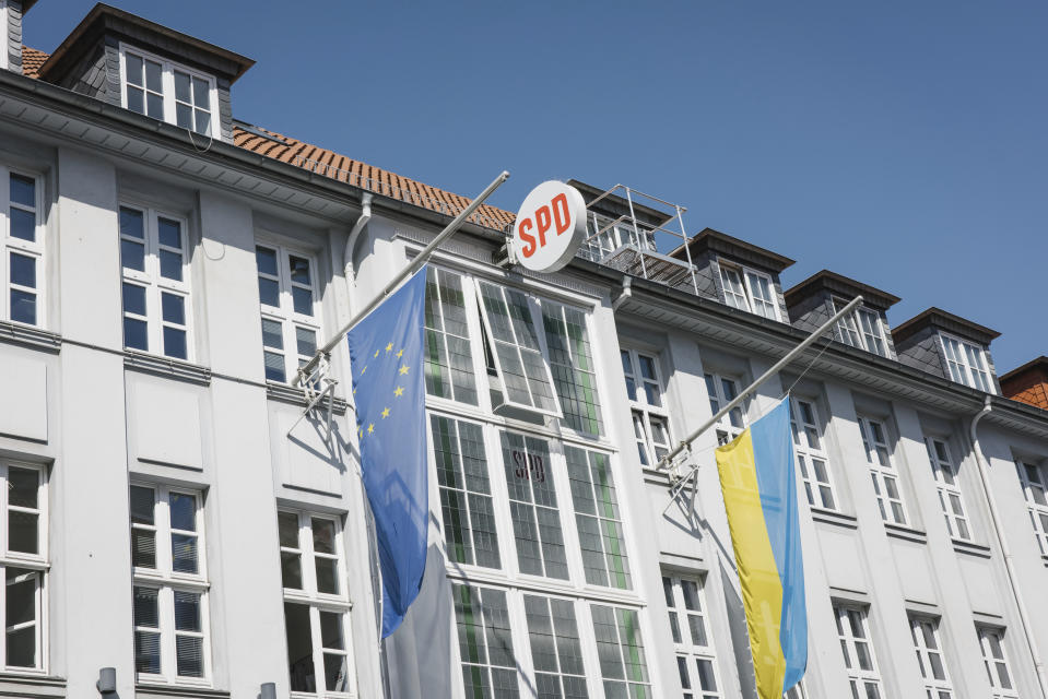 The flag of Ukraine and the EU fly at the Kurt Schumacher House in Hanover, Germany, Thursday, July 14, 2022. Local officials with German Chancellor Olaf Scholz’s party have met to consider calls to expel former Chancellor Gerhard Schroeder. The ex-leader's longstanding ties to the Russian energy sector and refusal to distance himself fully from President Vladimir Putin after Russia invaded Ukraine have left his political standing in tatters. (Ole Spata/dpa via AP)