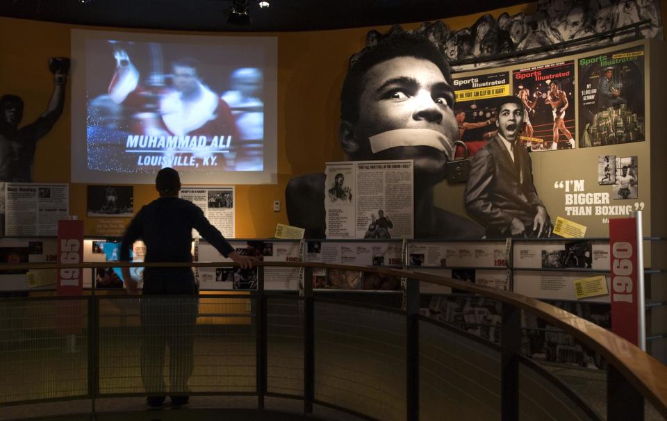 FILE - In this Wednesday, Jan. 11, 2012 file photo, Ben Physick of Austrailia watches the life of Muhammad Ali in video clips on display at the Muhammad Ali Center in Louisville, Ky. Visitors to the Muhammad Ali Center see the three-time world heavyweight champion in his prime, railing against war and racial inequity and delivering knockout punches in the ring. They also see the softer side of a man embracing ideals of respect and spiritual growth. Although Louisville is best-known for the Derby, visitors in town for the May 5, 2012 race will find plenty of other things to do and see around town, from museums to historic hotels to trendy restaurants. (AP Photo/Brian Bohannon)