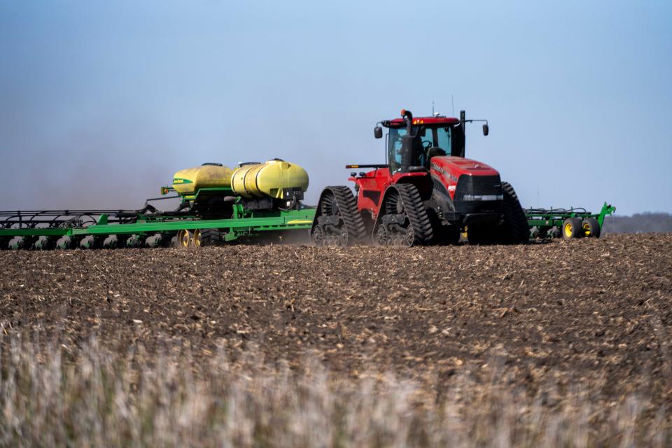 Marcus Heineman, at the wheel, plants corn Wednesday near Ogden in Boone County.