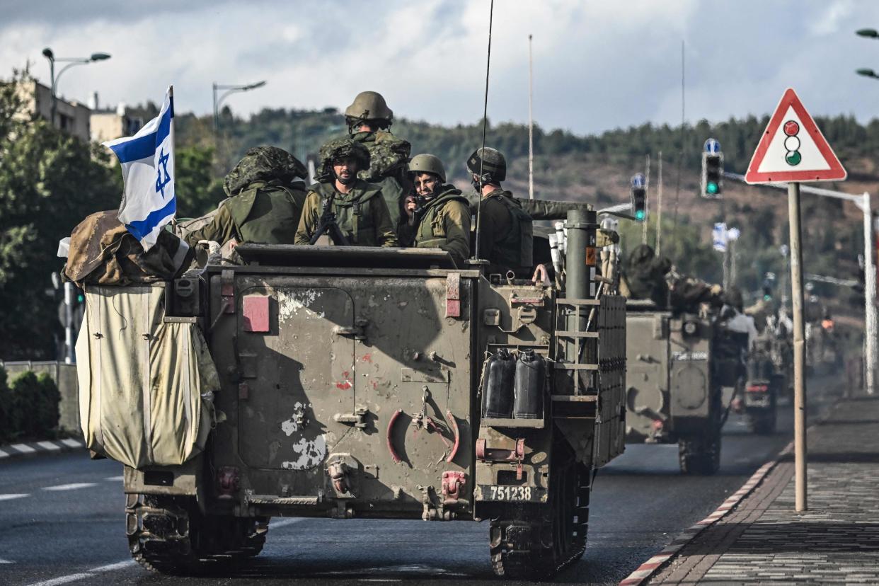 Israeli soldiers patrol in armoured personnel carriers at in northern Israel near the Lebanon border (AFP via Getty Images)