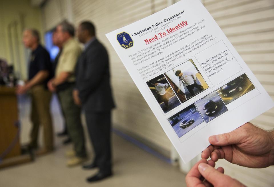Charleston Emergency Management Director Mark Wilbert on Thursday holds a flier that was distributed to media with surveillance footage of a suspect wanted in connection with the shooting. (Photo: David Goldman)