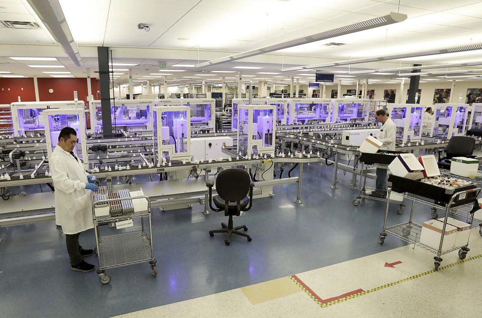 In this March 10, 2020, photo, lab technologists place specimens onto the specimen distribution system at the Mayo Clinic Superior Drive facility in Rochester, Minn. Vice President Mike Pence has an appointment Tuesday at Minnesota’s Mayo Clinic to learn about a new coronavirus testing “moonshot” that has the famed clinic partnering with the state and its flagship university to quickly boost the state's capacity to 20,000 tests a day. (David Joles/Star Tribune via AP)