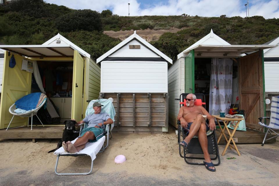 Sunseekers will enjoy the clearer skies this week (PA)