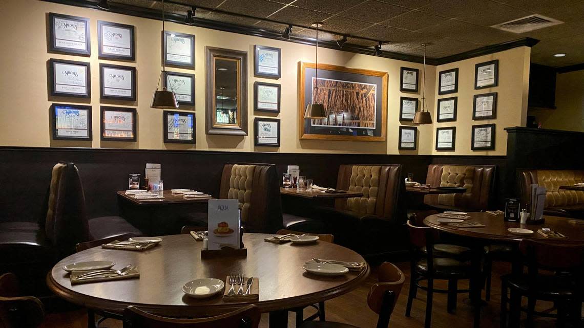 The dining room at Malone’s Lansdowne restaurant location in Lexington. The owners say the idea for putting up signed menus on the walls came as a way for cheap decoration.