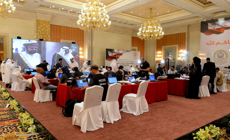 Journalists work in the Kuwait Ministry of Information's press center at the Al Raya ballroom in Kuwait City on Monday, March 24, 2014. The country is preparing to host the annual Arab League Summit scheduled for March 25 and 26.(AP Photo/Nasser Waggi)