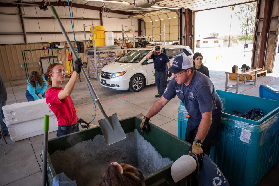 Firefighters and volunteers with distribute dry-ice bags and water supplies after Sunday's monsoon storm left thousands of residents without power in Eloy on July 19, 2022.