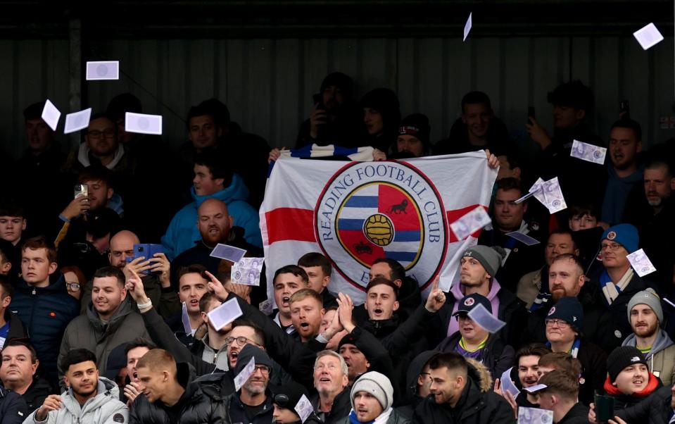 Reading fans throw fake money, tennis balls and flares onto the pitch in protest of owner Dai Yongge during the Emirates FA Cup second round match at the Silverlake Stadium, Eastleigh