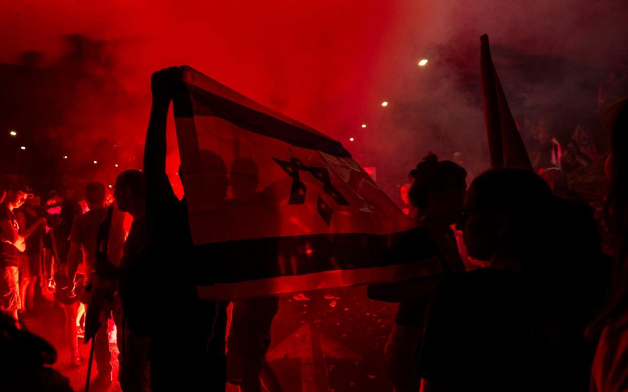 People block a road as they protest on Sunday night