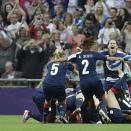 Great Britain's players celebrate after they scored against Brazil during their preliminary round Group E group women's soccer match at Wembley Stadium, during the London 2012 Summer Olympics, in London, Tuesday, July 31, 2012. (AP Photo/Lefteris Pitarakis)