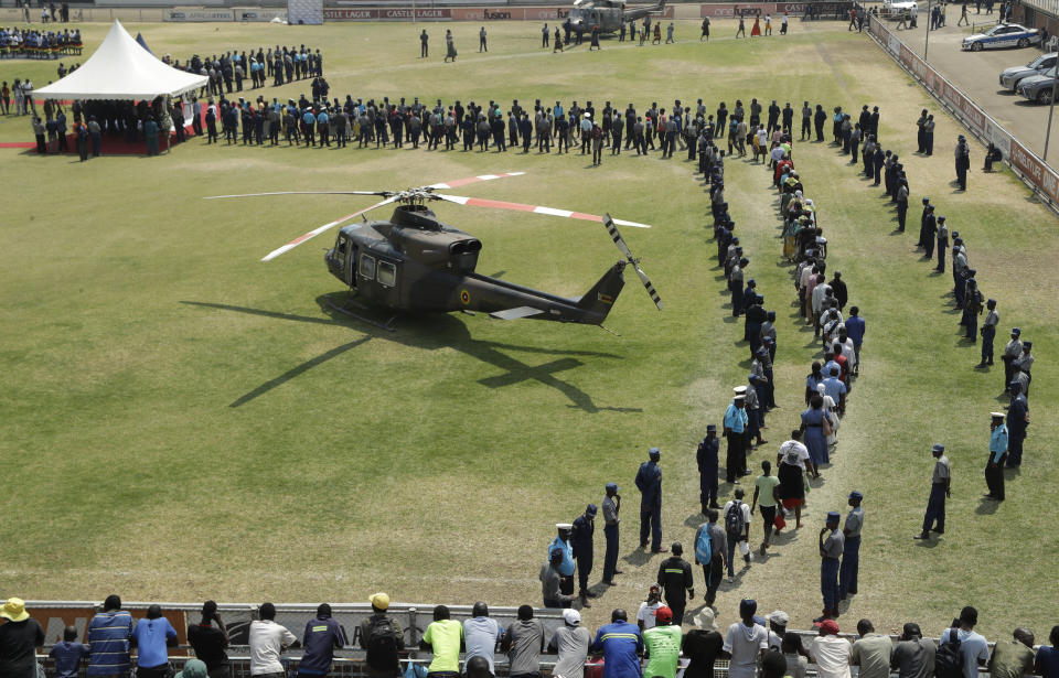 A helicopter carrying the coffin of former Zimbabwean President Robert Mugabe lands at the Rufaro Stadium in Harare, Friday, Sept. 13, 2019, where the body is on view at the stadium for a second day. Mugabe died last week in Singapore at the age of 95. He led the southern African nation for 37 years before being forced to resign in late 2017. (AP Photo/Themba Hadebe)