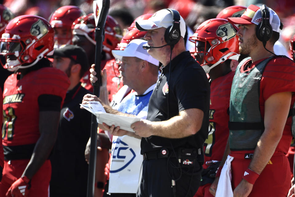 Louisville head coach Jeff Brohm, center, looks on from the sideline during the first half of an NCAA college football game against SMU in Louisville, Ky., Saturday, Oct. 5, 2024. (AP Photo/Timothy D. Easley)