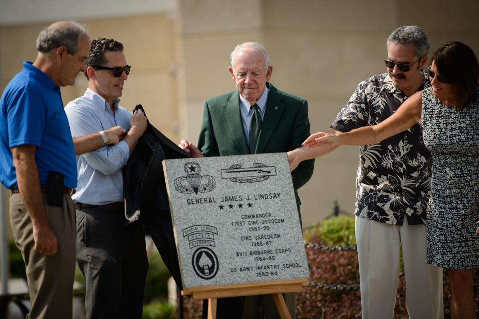 Retired Gen. James Lindsay, center, and family and friends unveil a paver in Lindsay's honor during the National Airborne Day celebration ceremony Saturday, Aug. 15, 2015, at the Airborne & Special Operations Museum.