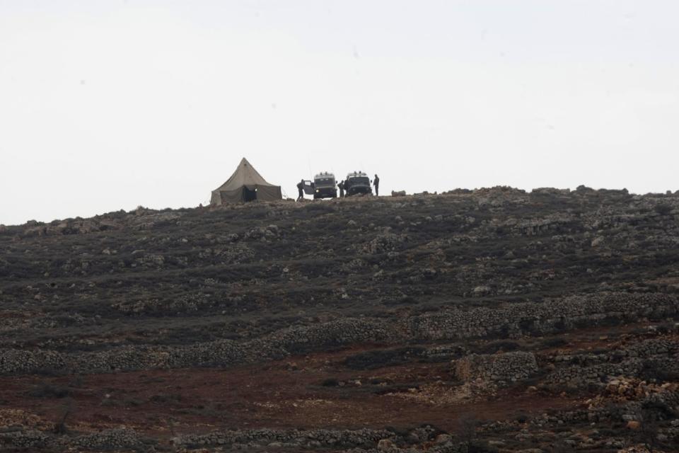 The Israeli military places a tent near the West Bank village of Qusra, southeast of Nablus, Tuesday, Jan. 14, 2014. The annual rate of Israeli settler attacks against Palestinians has almost quadrupled in eight years, U.N. figures show, buttressing claims that Israeli security forces have largely failed to stem the so-called "price tag" campaign in which thugs cut down trees, deface mosques and beat Palestinian farmers. (AP Photo/Nasser Ishtayeh)