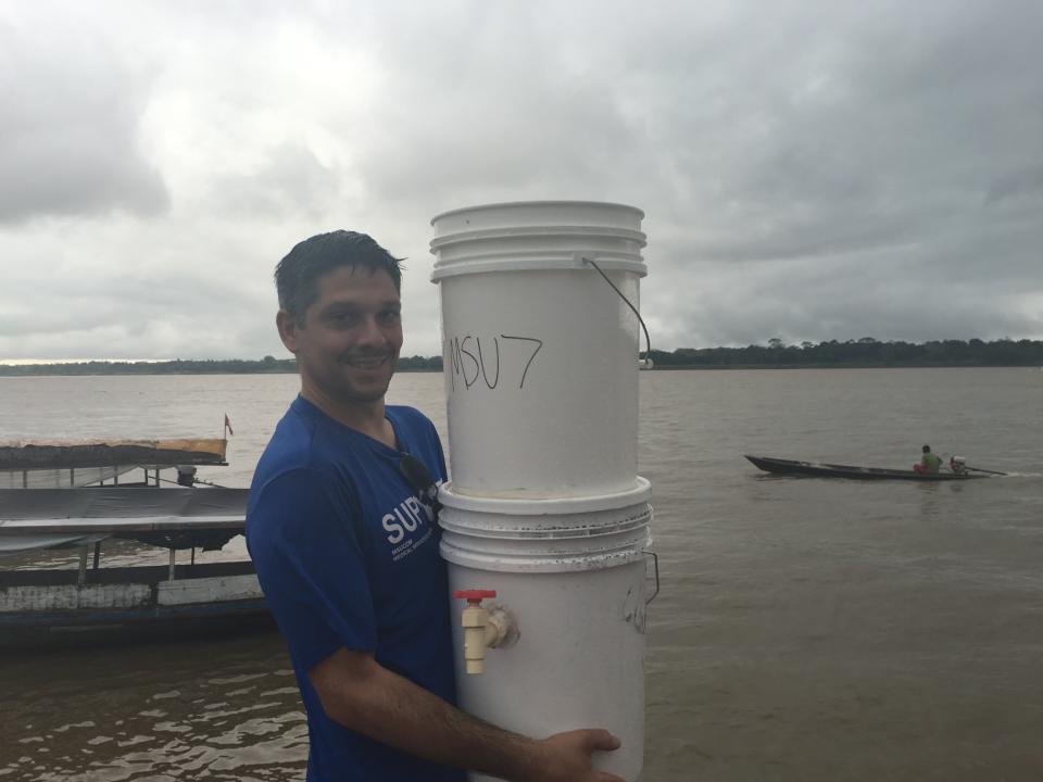 Dr. Shane Sergent is shown when he was working on a project to improve drinking water along the Amazon River using sustainable bio film filters.