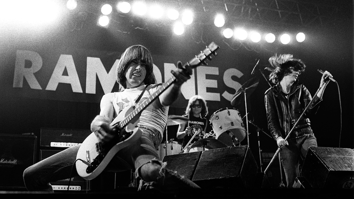  Johnny Ramone and Joey Ramone and Tommy Ramone playing live on stage. 