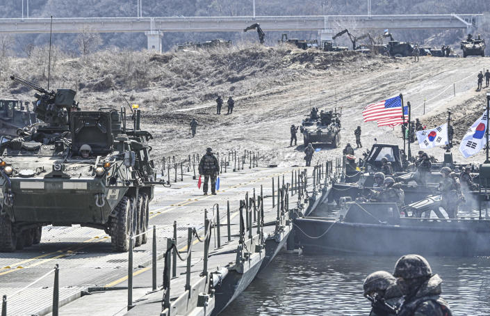 In this photo provided by South Korea Defense Ministry, U.S. military armored vehicles cross a river during a joint river-crossing drill between South Korea and the United States in Yeoncheon, South Korea, Monday, March 13, 2023. (South Korea Defense Ministry via AP)