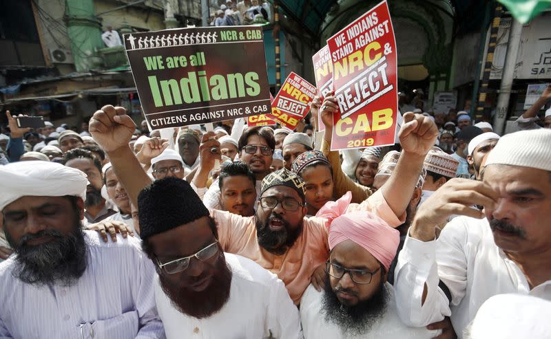 People hold placards and shout slogans during a protest against the Citizenship Amendment Bill in Mumbai,