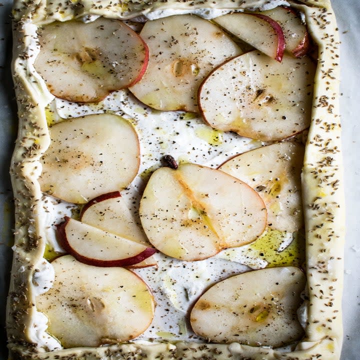 a tart before baked with ricotta and sliced pears