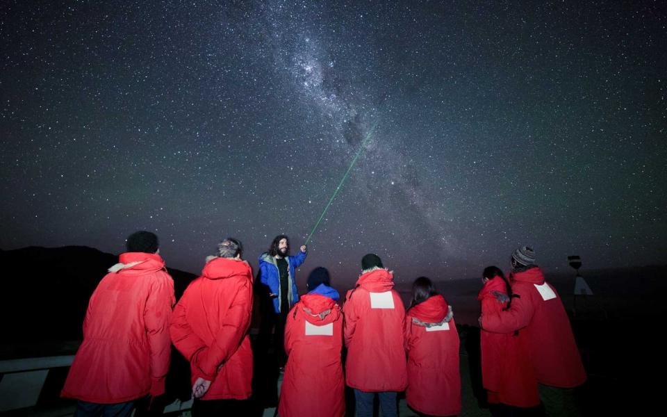 Laser pointer guide pointing out constellations in New Zealand