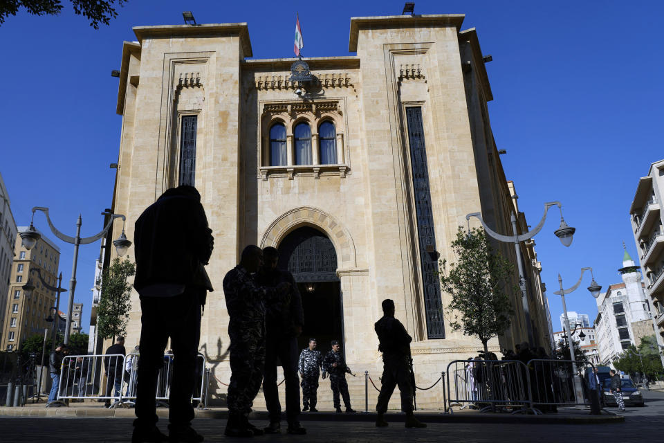 Security forces stand guard in front of the parliament building where lawmakers gather to elect a president in Beirut, Lebanon, Thursday, Jan. 19, 2023. The Lebanese pound's value Thursday hit an all-time low, now trading at 50,000 to the U.S. dollar, as the country's deeply-divided parliament failed to elect a president for an 11th time. (AP Photo/Bilal Hussein)