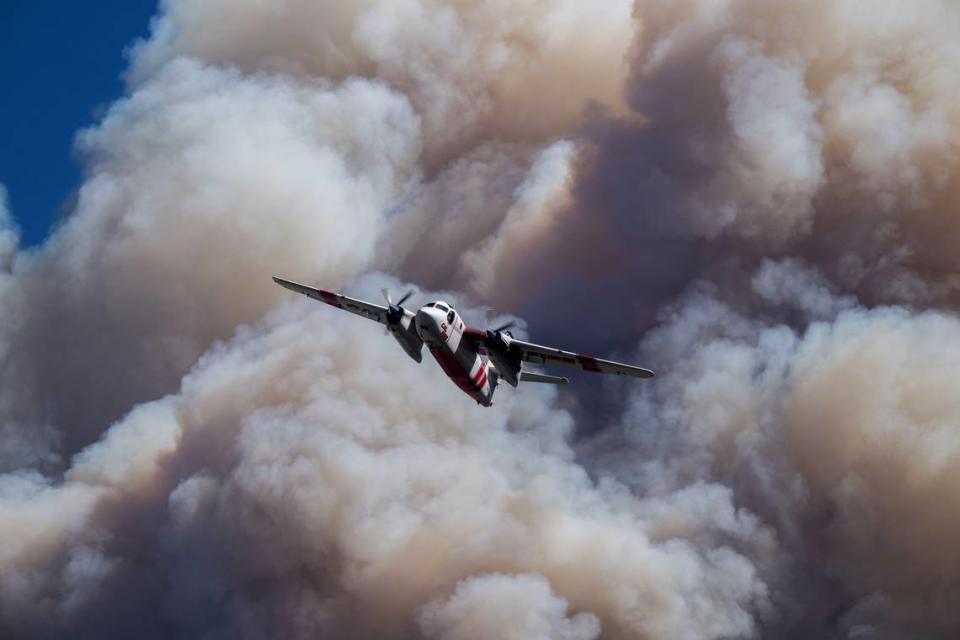 A Cal Fire S-2T airtanker flies near smoke from the Park Fire near Cohasset Road east of Chico on July 25.