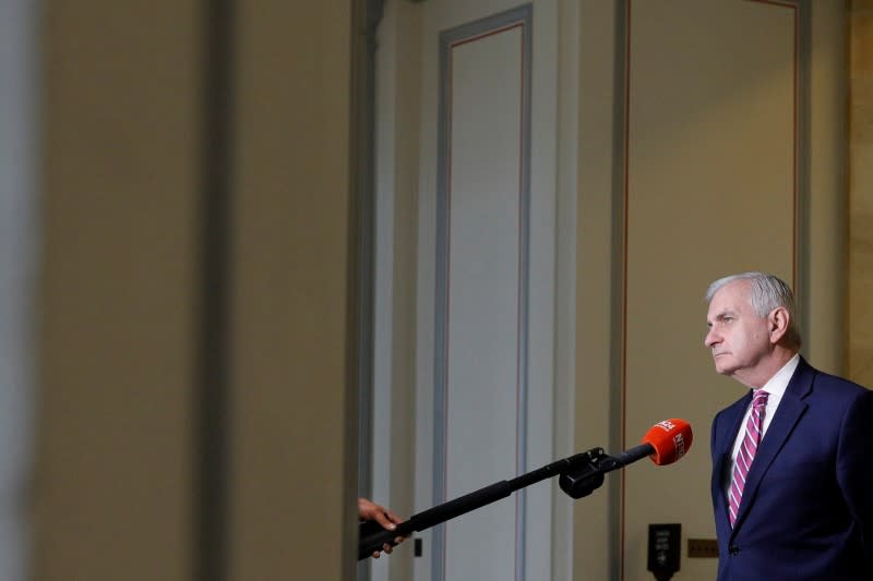 Senator Reed speaks to a news reporter through an extended microphone ahead of a vote on the coronavirus relief bill on Capitol Hill in Washington