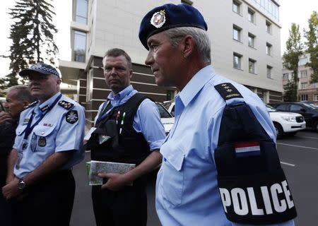 Head of Australian Federal Police mission Commander Brian McDonald (L), Alexander Hug (C), deputy head for the Organisation for Security and Cooperation in Europe's (OSCE) monitoring mission in Ukraine and Dutch police officer Kuijs arrive back from the site where the downed Malaysian airliner MH17 crashed, in Donetsk July 31, 2014. The OSCE security and rights organisation said its monitors, accompanied by Dutch and Australian experts, reached the crash site of a Malaysian airliner in eastern Ukraine on Thursday, two weeks after the plane came down. REUTERS/Sergei Karpukhin