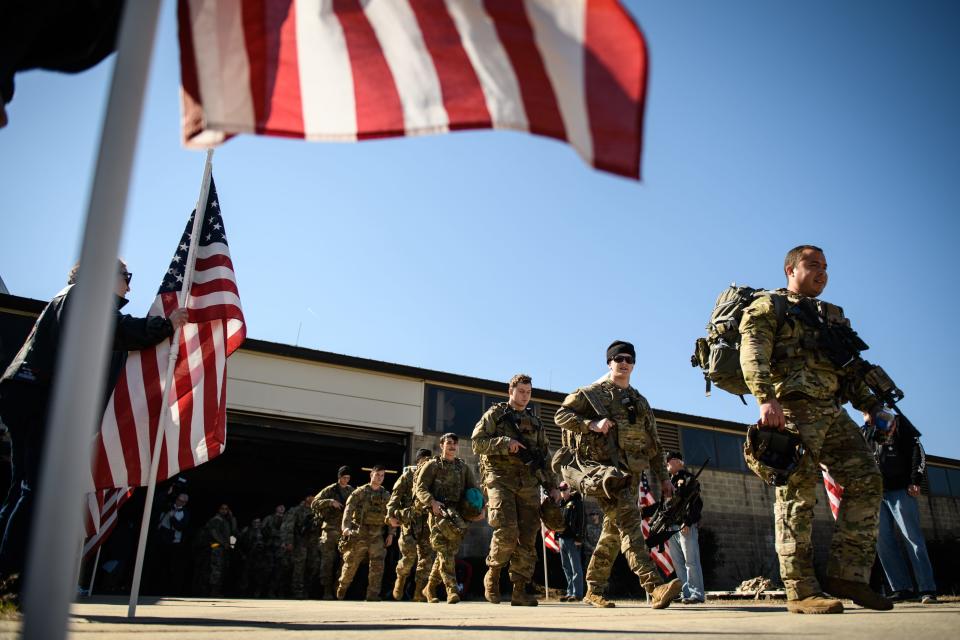 Paratroopers from Fort Bragg's 82nd Airborne Division head out to board a plane on Feb. 14, 2022, on Pope Army Airfield. They are among soldiers the Department of Defense is sending to Poland amid a growing Russian presence near Ukraine. The Fort Bragg name will change to Fort Liberty.