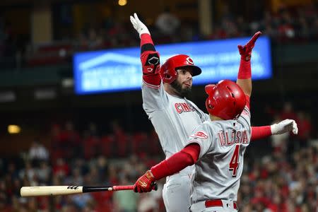 Apr 26, 2019; St. Louis, MO, USA; Cincinnati Reds left fielder Jesse Winker (33) leaps to celebrate with shortstop Jose Iglesias (4) after hitting a solo home run off of St. Louis Cardinals starting pitcher Miles Mikolas (not pictured) during the fourth inning at Busch Stadium. Mandatory Credit: Jeff Curry-USA TODAY Sports