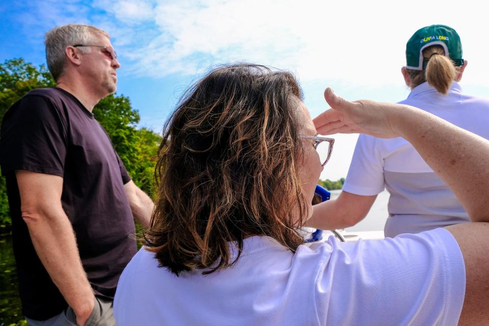 Mike and Arana Long take a look at the new boat dedicated to their daughter, Olivia, as it makes its way on the Grand River after a dedication ceremony Saturday, Sept. 17, 2022. Olivia was a member of the Michigan State Rowing Team and was killed in a car crash in August of 2021.