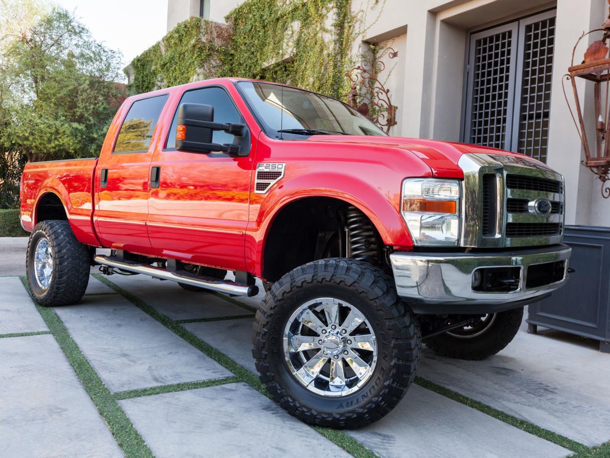 A parked red 2008 Ford F250 truck