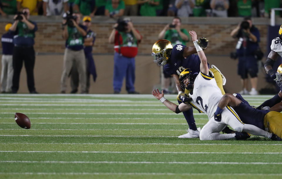 Michigan quarterback Shea Patterson (2) fumbles the ball against Notre Dame in the second half of an NCAA football game in South Bend, Ind., Saturday, Sept. 1, 2018. Notre Dame won 24-17. (AP Photo/Paul Sancya)